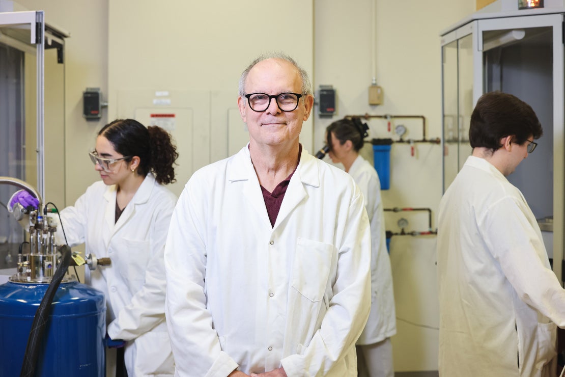 Doug Stephan examines a crystal for X-ray diffraction studies.