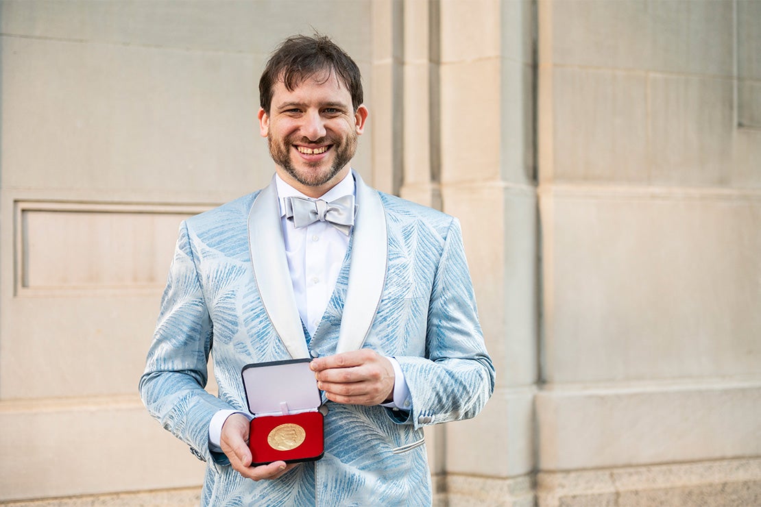 Jacob Tsimerman holds the Fields Medal.